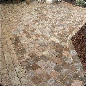 Close view of a stone paver walkway under construction.