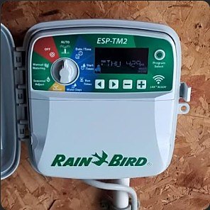 Rain Bird ESP-TM2 irrigation controller mounted and wired during a repair.